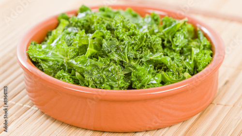 Curly Kale - Cooked cale in an earthenware dish.