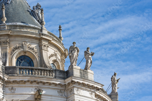 Roof with ornaments and statues Palace Versailles near Paris, France