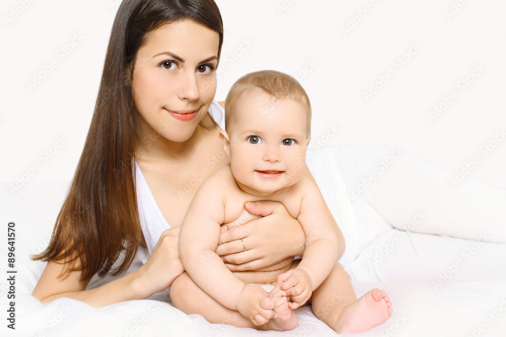 Portrait of cute baby and mother together on the bed Portrait of cute baby and mother together on the bed