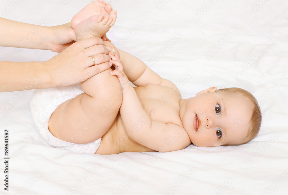 Mother playing with cute baby at home on the bed Mother playing with cute baby at home on the bed