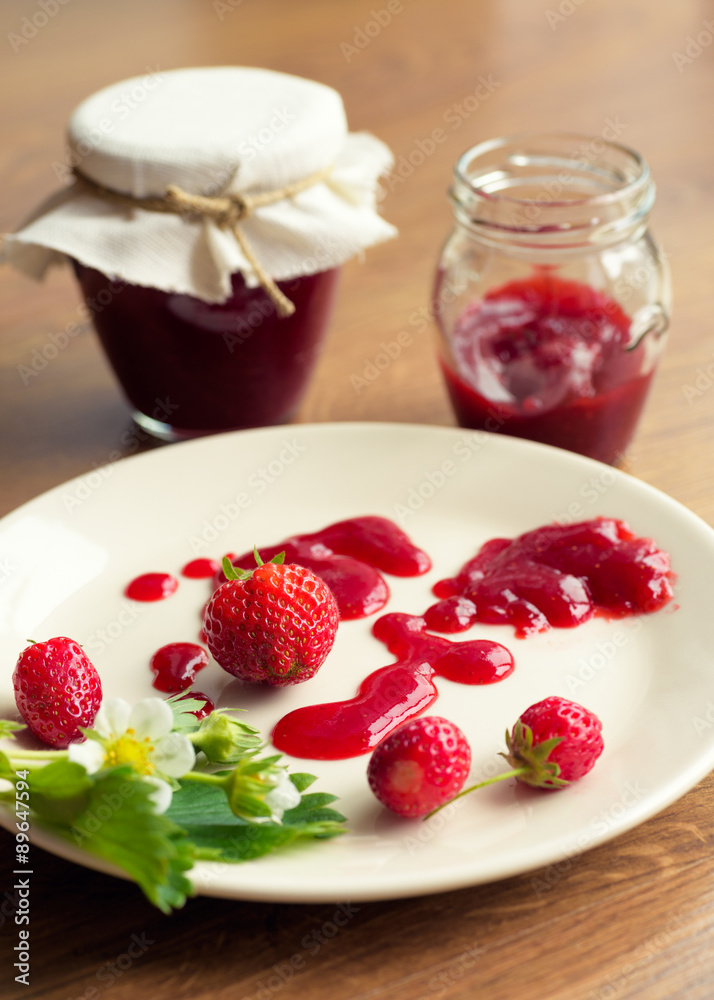 Homemade strawberry jam (marmelade) in jars on wooden background. Homemade strawberry jam (marmelade) in jars on wooden background.