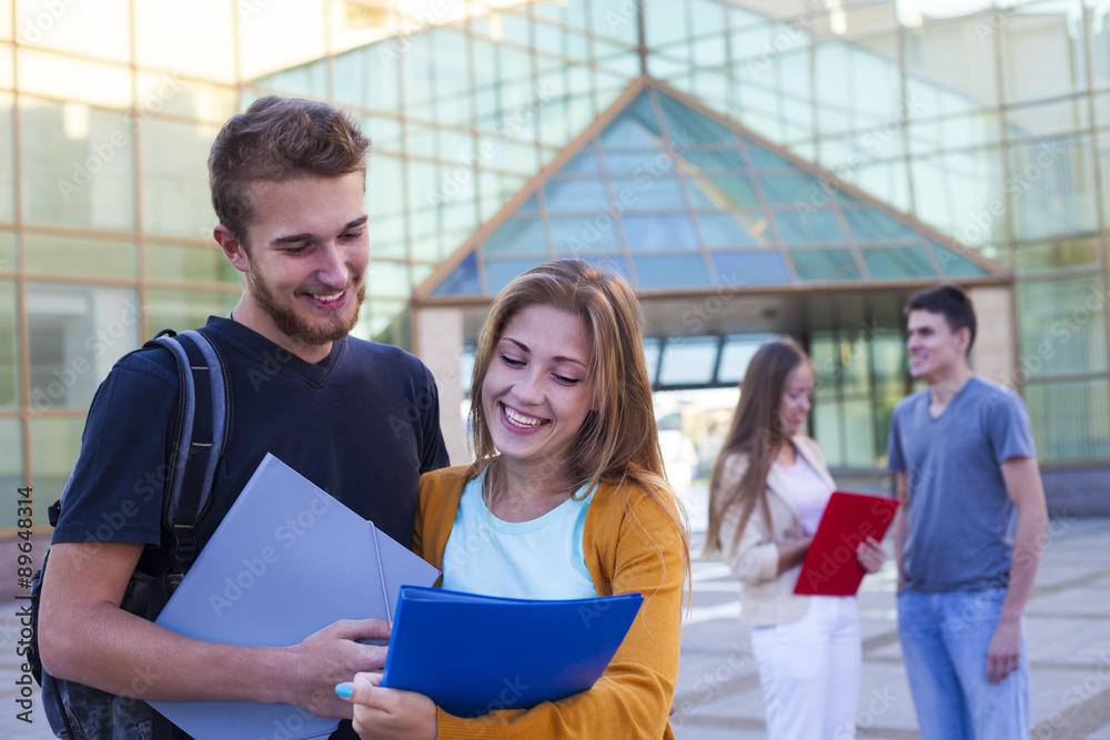 Happy student having conversation next modern college. Education concept Happy student having conversation next modern college. Education concept