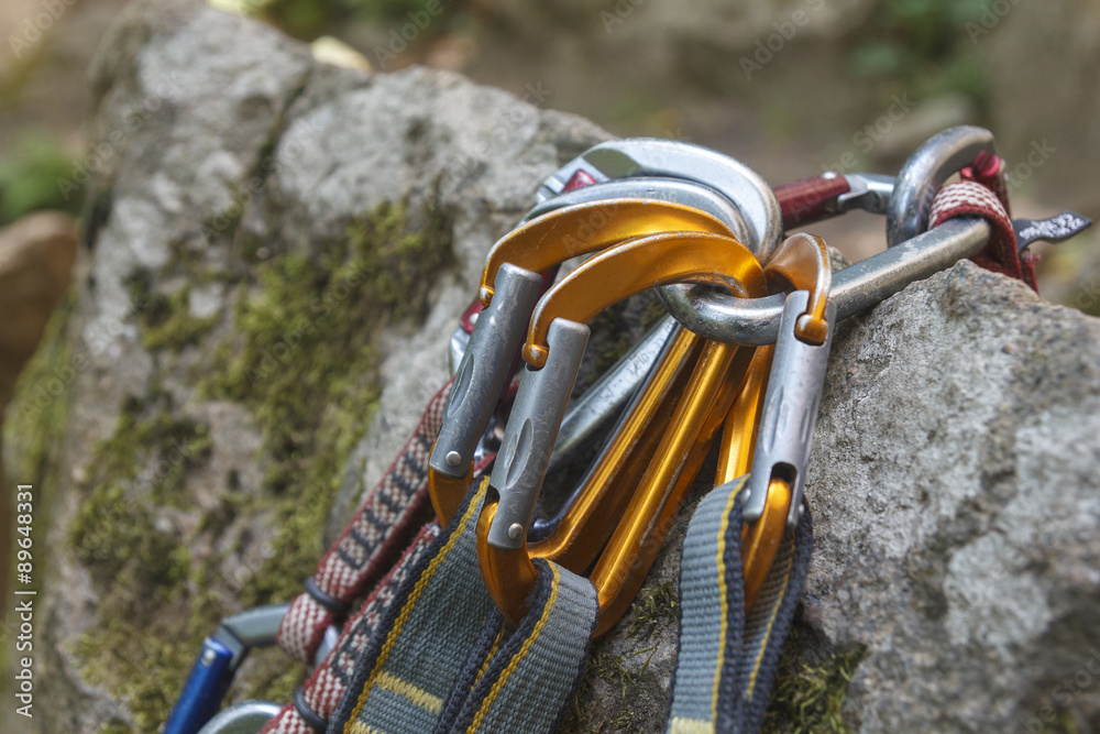 Climbing. A bunch of carabiners on the rocks. Granite rocks