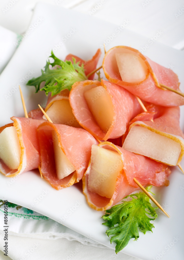 Slices of melon wrapped with ham