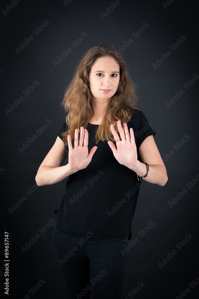 Beautiful woman doing different expressions in different sets of clothes: stop sign Beautiful woman doing different expressions in different sets of clothes: stop sign