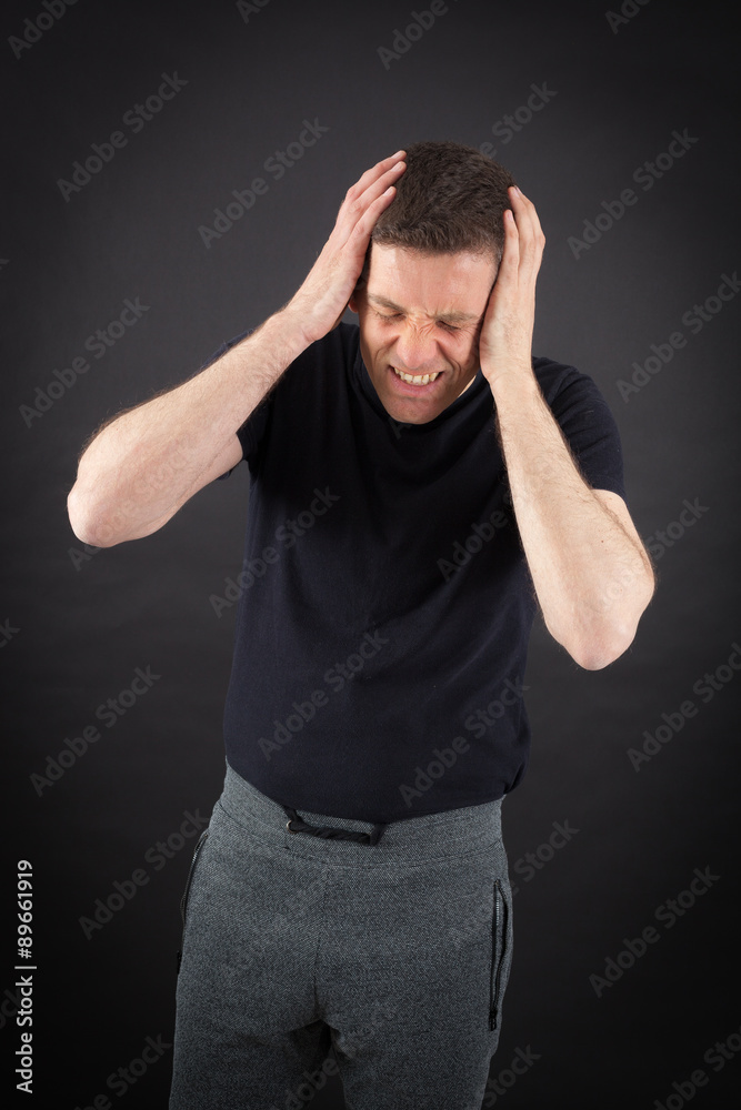 Handsome man doing different expressions in different sets of clothes: headache Handsome man doing different expressions in different sets of clothes: headache