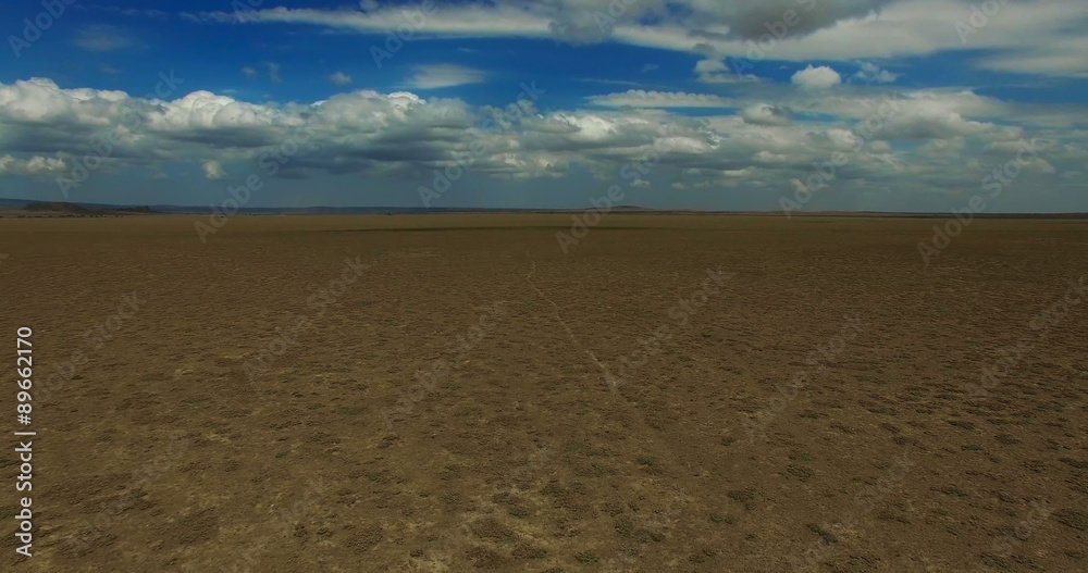 Aerial view flying over Tanzania desert. Car moving on road. Africa. Travel tourism adventure in wild nature camera bird eye view. Aerial view flying over Tanzania desert. Car moving on road. Africa. Travel tourism adventure in wild nature camera bird eye view.