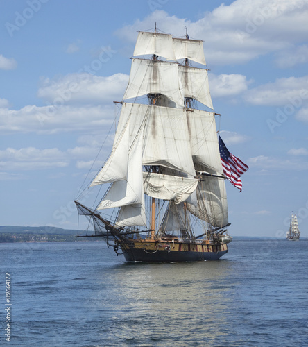 Photography Tall ship with American flag sailing on blue waters