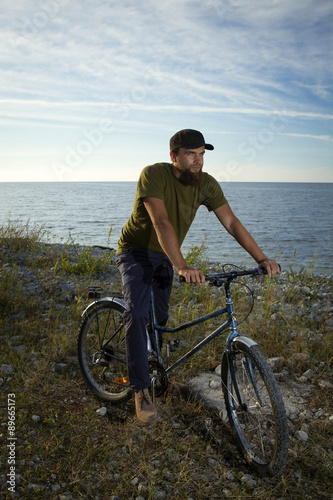 man on a bicycle near the sea.