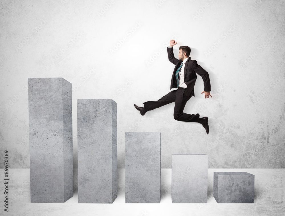 Successful business man jumping over charts on background Successful business man jumping over charts on background