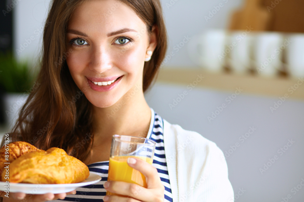 Young woman with glass of juice and cakes Young woman with glass of juice and cakes
