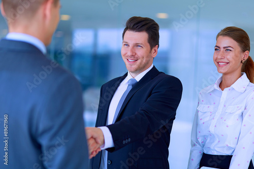 Two successful business men shaking hands with each other