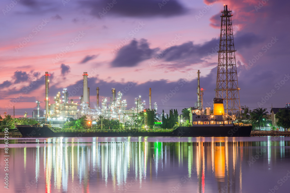 Fototapeta premium Oil tank ship mooring in oil refinery industry at twilight time