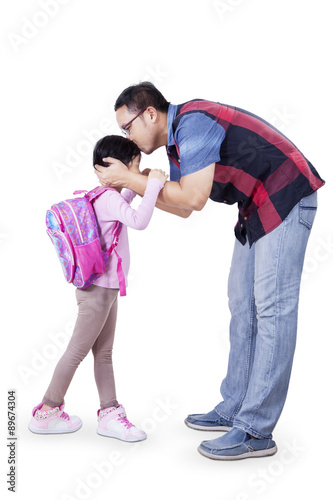 Dad kiss his daughter before go to school