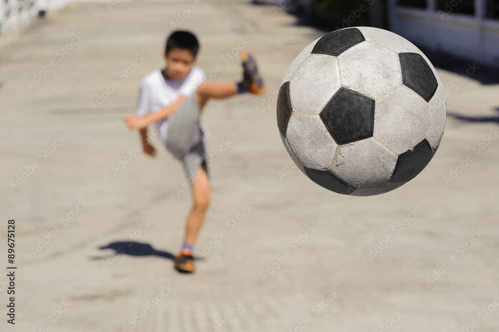 Boy kick football fly to near