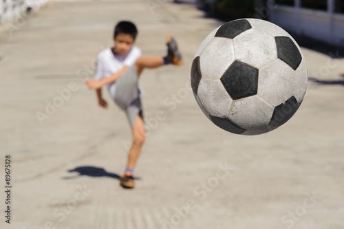 Boy kick football fly to near © TinPong