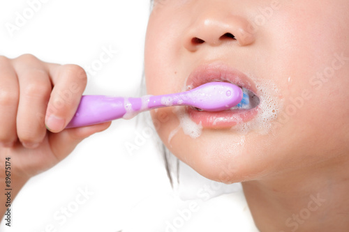 Little asian girl brush teeth