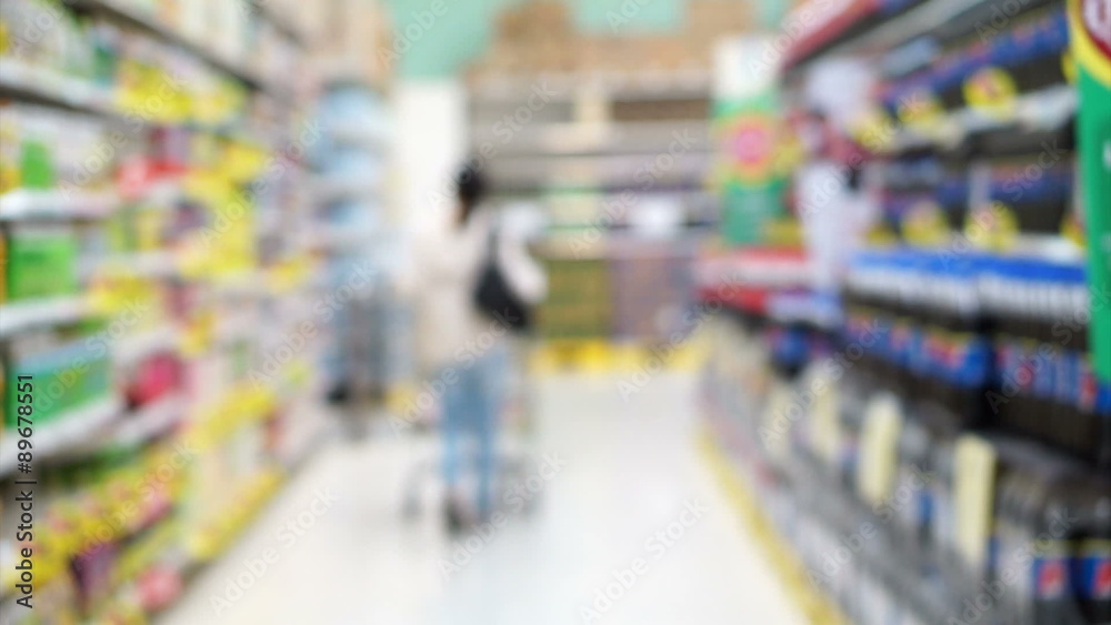 Asian girl, woman walking, looking and shopping snacks in blur supermarket isle Asian girl, woman walking, looking and shopping snacks in blur supermarket isle