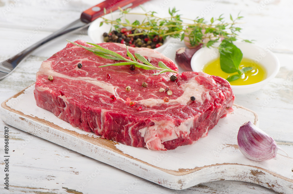 Raw Steak - raw rib eye steaks on the cutting board