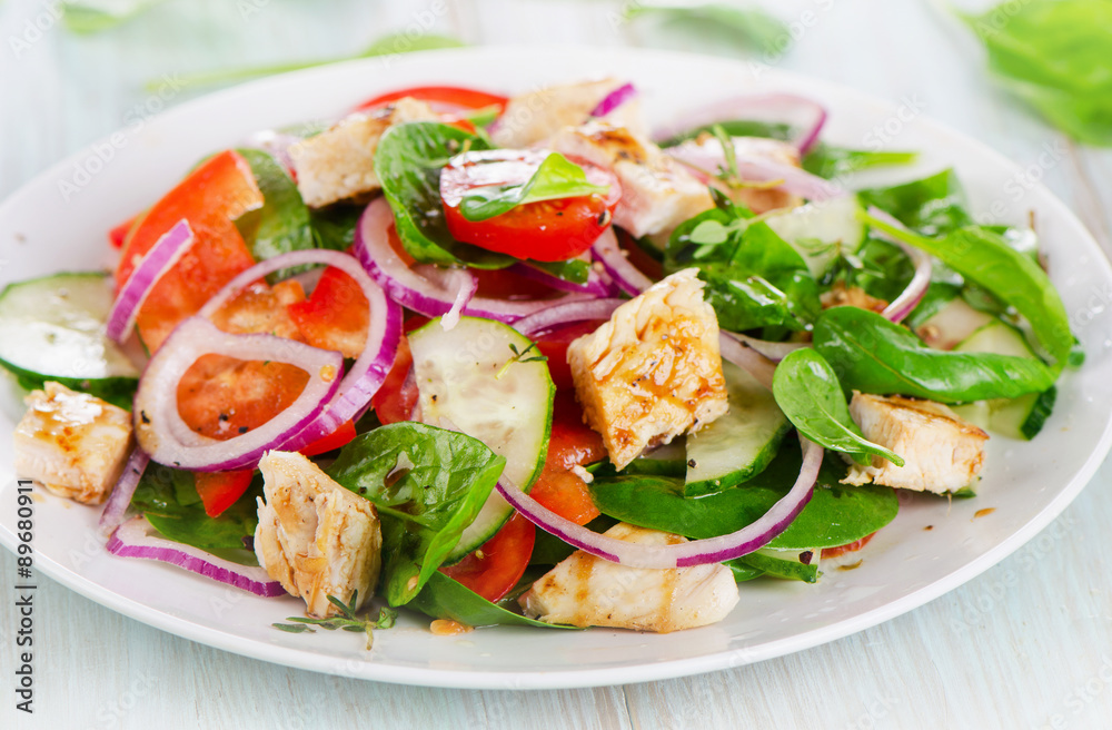 Healthy salad with grilled chicken breast.