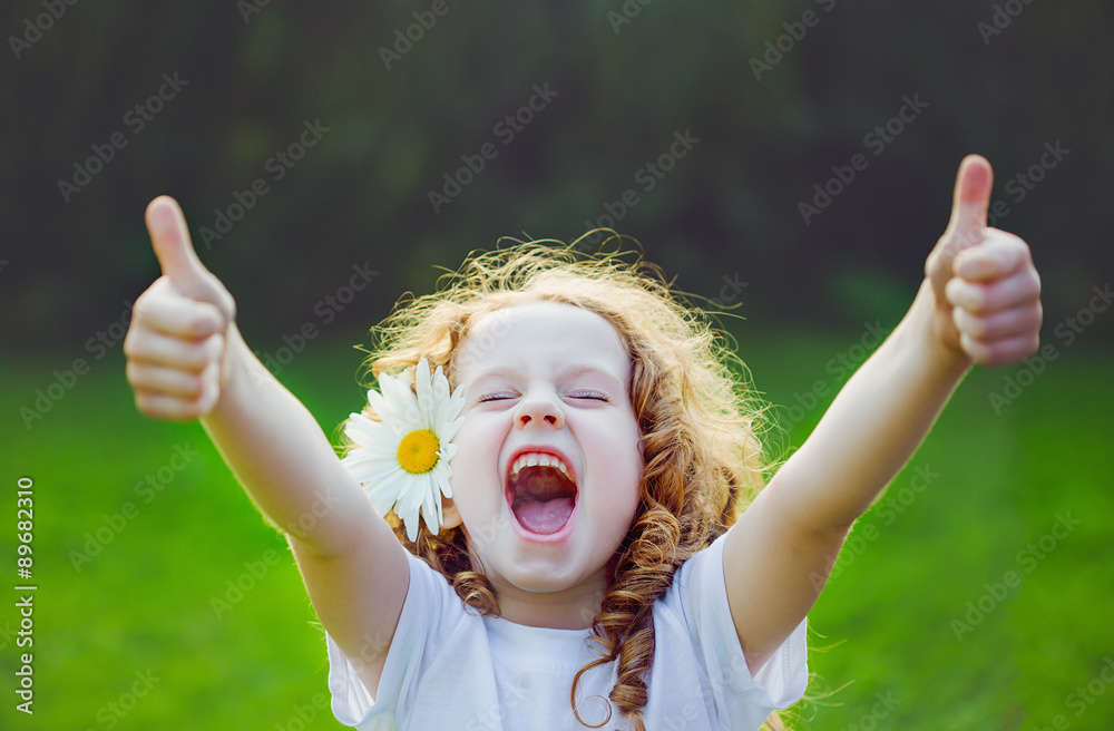 Laughing girl showing thumbs up. - obrazy, fototapety, plakaty 