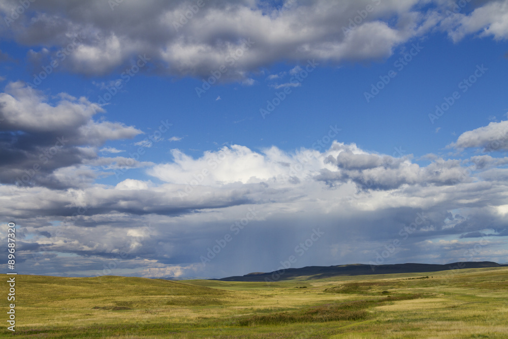 hilly valley, meadows, pastures and cloudy sky