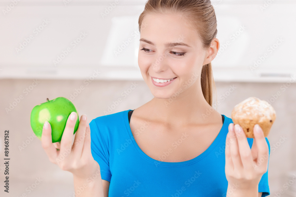Nice girl holding apple and muffin Nice girl holding apple and muffin
