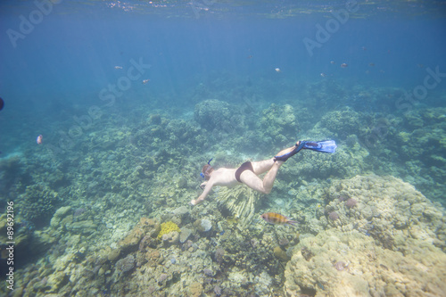 Man snorkeling underwater on coral reef