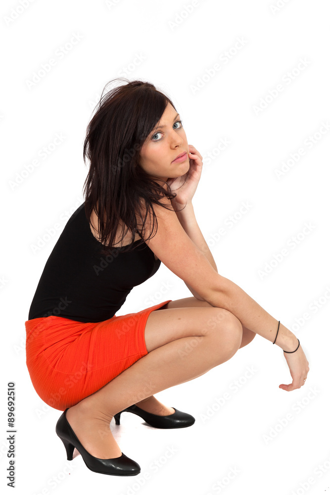 Beautiful woman doing different expressions in different sets of clothes: kneeling