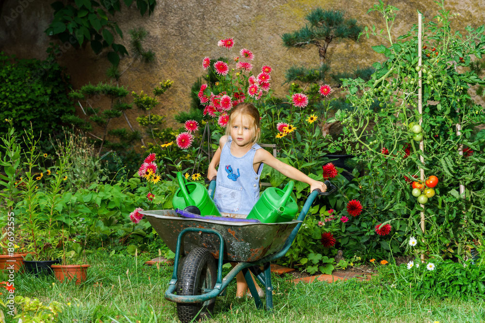 Cute little girl gardening in the backyard Stock Photo Adobe Stock