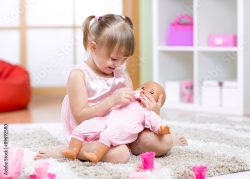 Cheerful little girl play in preschool photo