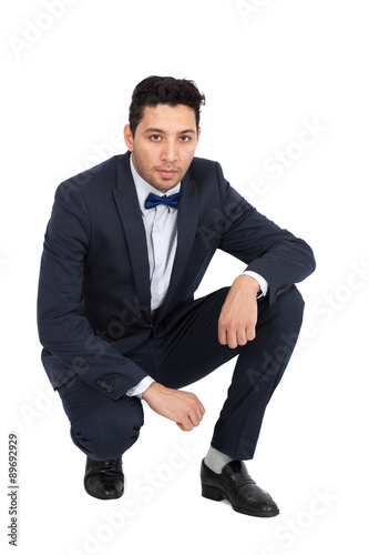 Handsome man doing different expressions in different sets of clothes: kneeling