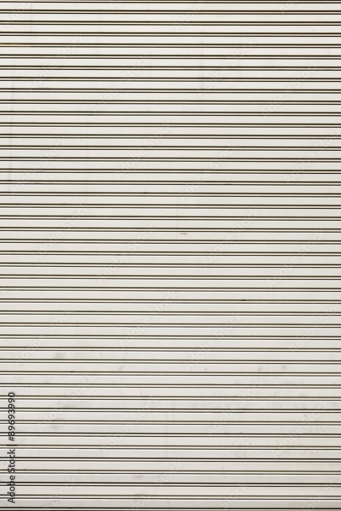 Steel shiny rolling shutter door texture with horizontal lines. Steel shiny rolling shutter door texture with horizontal lines.