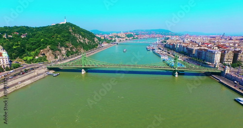 Hungary. Budapest bird eye view. Flying up Liberty Bridge Buda and Pest aerial view moving up camera. Travel tourism Landmark over Danube river. Freedom Bridge and Chain Bridge.