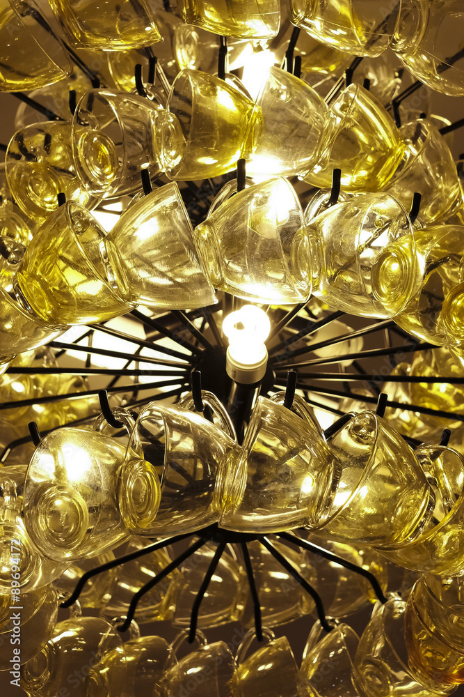 Close up Contemporary chandelier made of many yellow coffee cups Close up Contemporary chandelier made of many yellow coffee cups