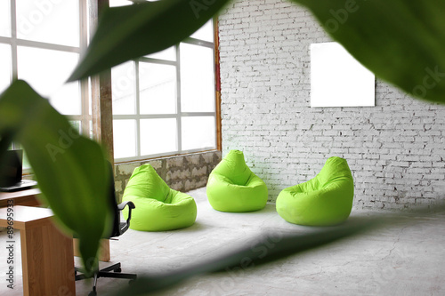  Interesting design on a background of white bricks with green decor