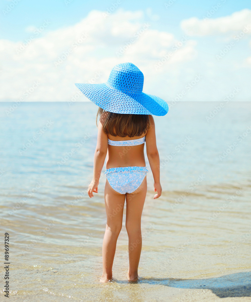 Back view of beautiful little girl child in swimsuit and straw h Stock  Photo | Adobe Stock