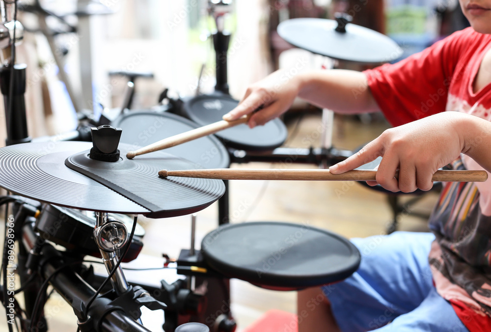 Fototapeta premium Unidentified Asian boy play electronic drum electronic drum