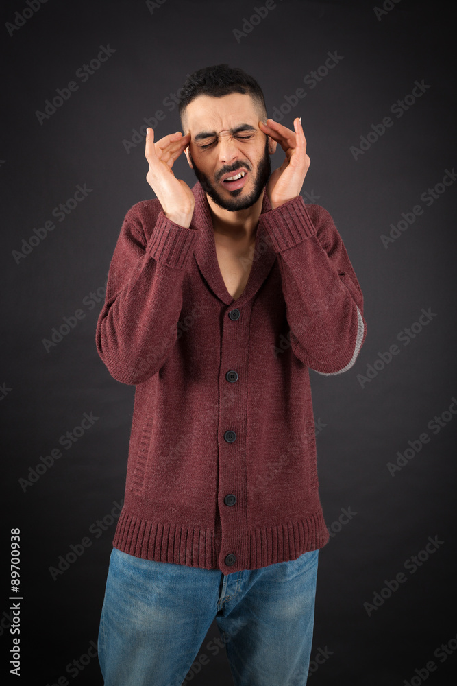 Handsome man doing different expressions in different sets of clothes: headache Handsome man doing different expressions in different sets of clothes: headache