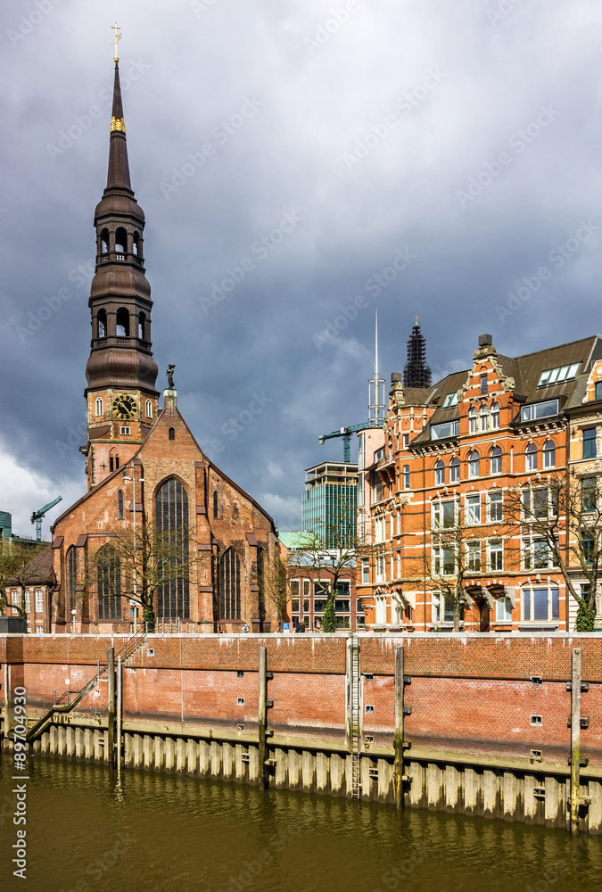 Fototapeta premium Hamburg, Germany. Cathedral church on canal embankment