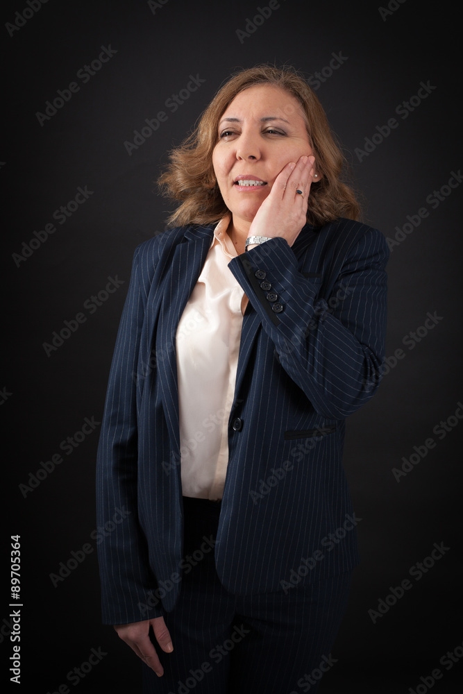 Beautiful woman doing different expressions in different sets of clothes: toothache Beautiful woman doing different expressions in different sets of clothes: toothache