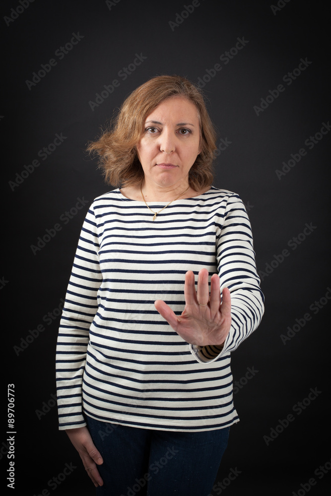 Beautiful woman doing different expressions in different sets of clothes: stop sign Beautiful woman doing different expressions in different sets of clothes: stop sign