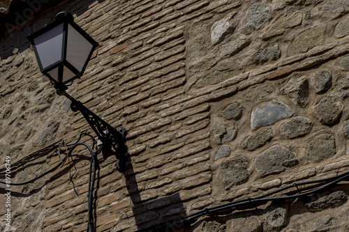Lamp, streets of the city Toledo, medieval architecture and Cast