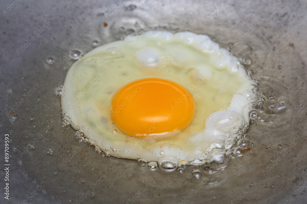 cooking fried egg in hot pan with oil cooking fried egg in hot pan with oil