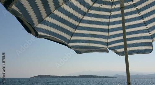 Sea with umbrella fragment on front in Urla  Izmir