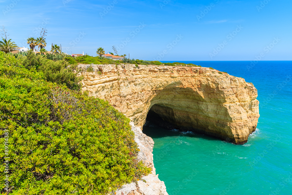 Cave in a cliff on coast of Portugal in Algarve region