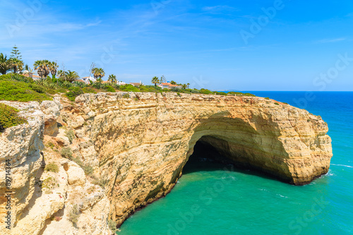 Cave in a cliff on coast of Portugal in Algarve region