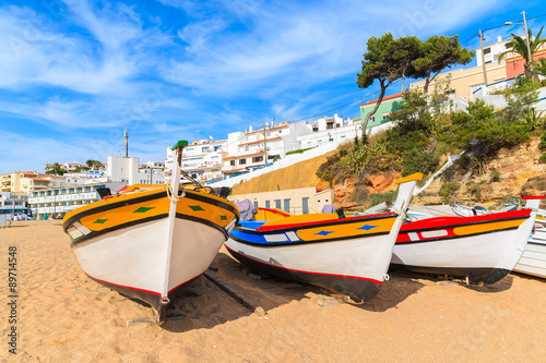 Traditional colourful fishing boats on beach in Carvoeiro village, Algarve region, Portugal
