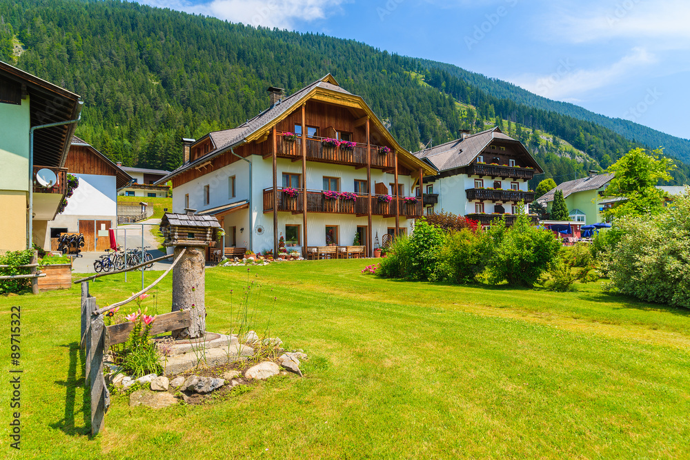 Traditional alpine houses in small village on shore of Weissensee lake, Austria