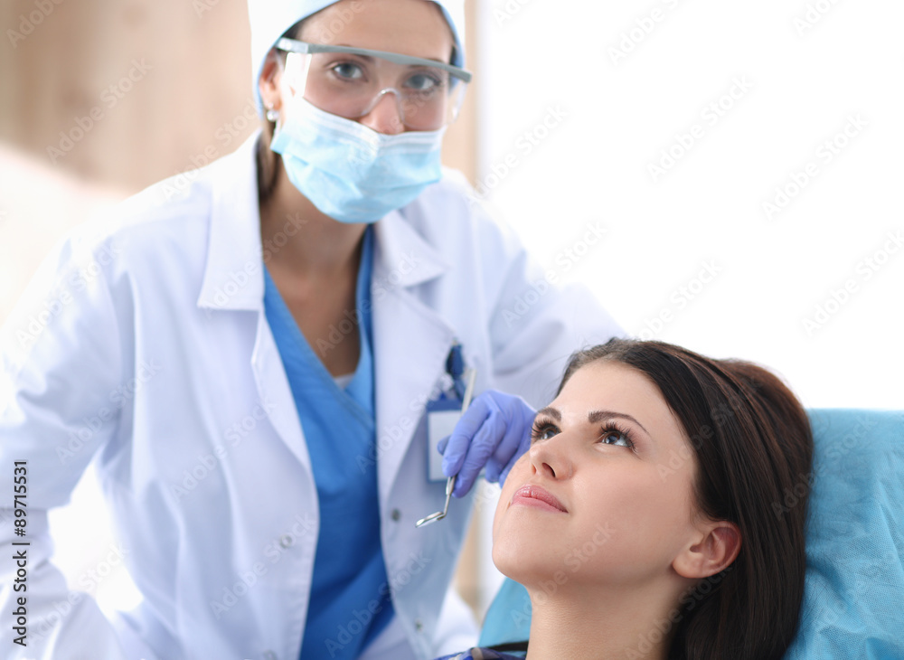 Woman dentist working at her patients teeth Woman dentist working at her patients teeth